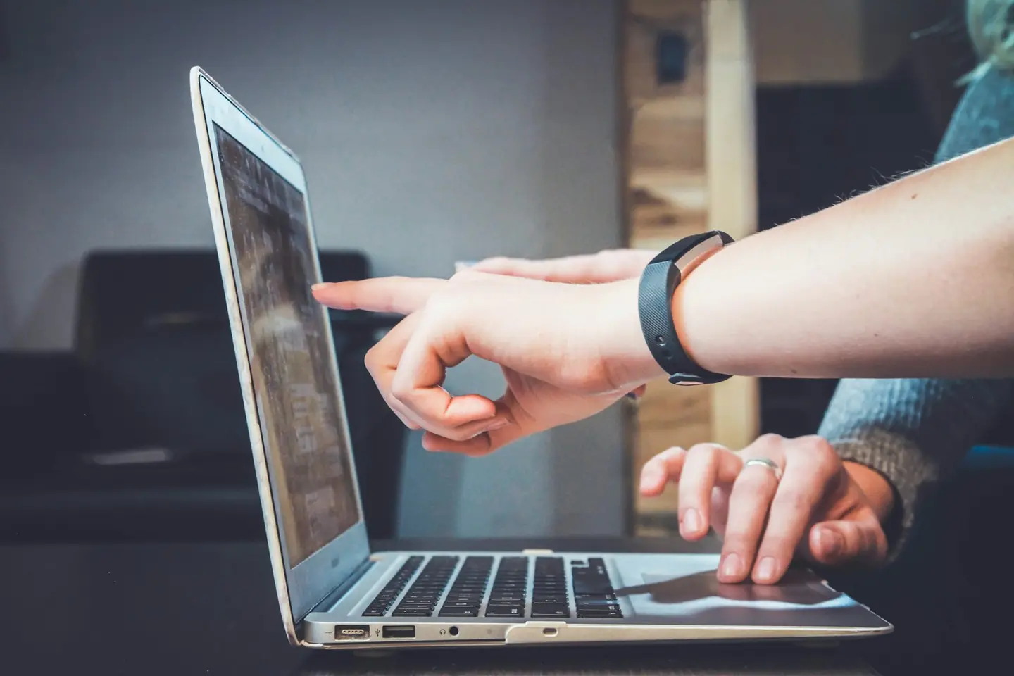 Two colleagues reviewing campaign data on a laptop